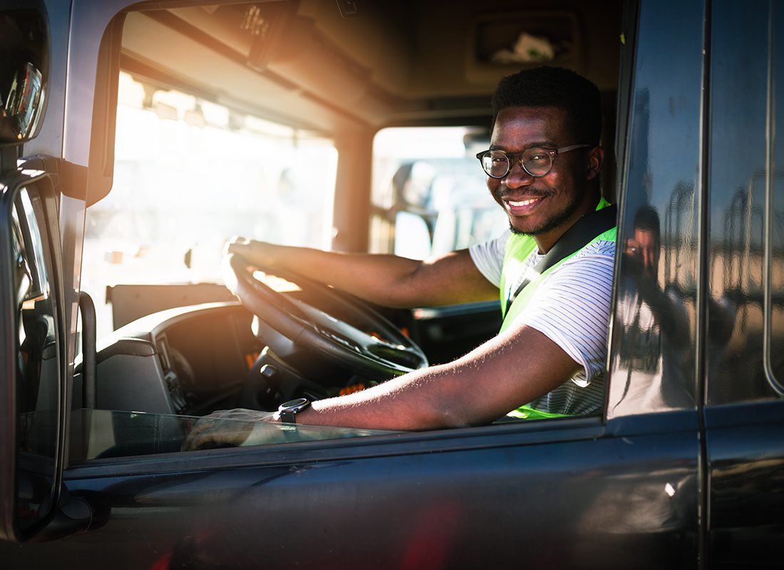 Insurance by Industry - Friendly Truck Driver Wearing an Yellow Vest